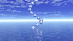 several balls floating in the air over water