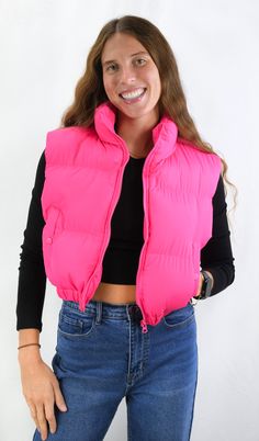 Perfect addition to your wardrobe. This puffer vest adds fashion and warmth to any outfit without the extra bulk. The vest has a front zipper with a high collar that can be turned down and snap pocks for a cute function in great colors. Color-Hot Pink (Also Available in Tan and Black) 100% Polyester Trendy Solid Vest For Cold Weather, Trendy Solid Color Cold Weather Vest, Sleeveless Puffer Jacket For Spring, Trendy Winter Vest With Zipper Closure, Trendy Cold Weather Vest Outerwear, Trendy Vest For Cold Weather, Trendy Vest Outerwear, Trendy Cold Weather Vest, Trendy Puffer Vest For Fall