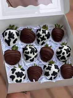 chocolate covered strawberries in a white box with black and white designs on them are ready to be eaten