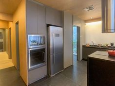 a modern kitchen with stainless steel appliances and counter tops