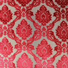 a red and white wallpaper with an intricate design on the back side of it