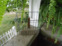 a wire basket on the side of a house