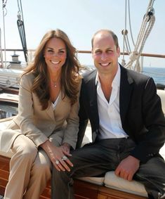 a man and woman sitting on the back of a boat