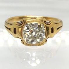 an antique diamond ring is shown on a white surface