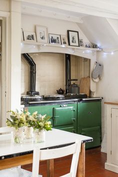 an old fashioned kitchen with green and white appliances