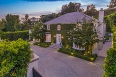 this is an aerial view of the house at dusk, with its driveway and landscaping