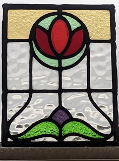 a stained glass window with a flower on it