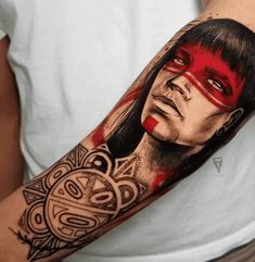 a man's arm with an image of a woman on it and some tattoos