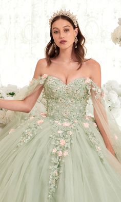 In this sage green quinceañera dress with romantic cape sleeves, it's easy to make an unforgettable entrance. The enchanting shade of green on this ball gown quinceañera dress is beautifully complemented by the blush pink 3-D that embellish the sequined embroidery on the bodice and glittering tulle skirt. More embroidery and flowers accent the off-the-shoulder cape sleeves that flow elegantly to the floor. Turn heads in this embroidered glitter quince dress with sequins. Sage Quinceanera, Floral Ball Gown, Cape Sleeve Dress, Cinderella Divine, Tulle Sleeves, Quinceanera Dress, Corset Back, Cape Dress, Dress Purchase