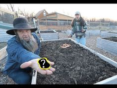 two people in a garden with one pointing at the camera and the other holding out his hand