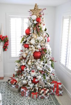 a decorated christmas tree with red and white ornaments