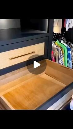 an open drawer with clothes in it