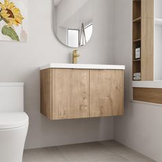 a white toilet sitting next to a wooden cabinet in a bathroom under a round mirror