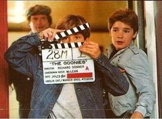 two young men holding up a movie clapper