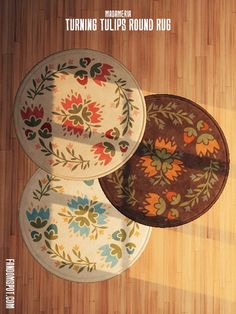 three round rugs sitting on top of a wooden floor