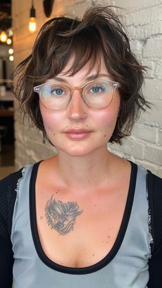 Sleek Sophistication: 22 Hairstyles for Round-Faced Women Over 50 Messy Short Hair Round Face, Shag For Round Faces, Bangs And Round Glasses, Short Curly Hair With Glasses, Wavy Bob With Bangs Round Face, Wavy Chin Length Hair With Bangs, Curly Bob Round Face Over 40, Hair Cuts For Rounder Faces, Bangs For Glasses Wearers