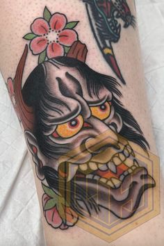 an old school japanese demon tattoo on the leg