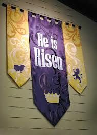 three purple and yellow banners hanging from the side of a wall with animals on them