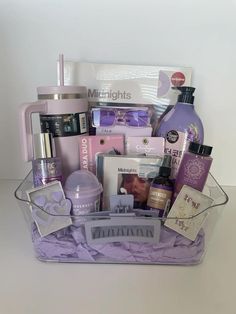 a purple basket filled with lots of beauty and personal care items on top of a table