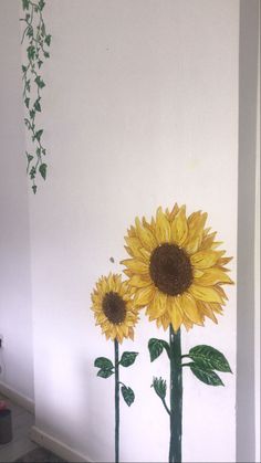 two sunflowers painted on the side of a wall