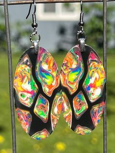 These unbelievable earrings are made from pure resin. Your eyes will go wild and my mind start reeling when you look deep into them. Not to mention what they look like under a black light These earrings are extremely lightweight. The ear wires are hypoallergenic surgical stainless steel. The earring pendants are 2" long. Artistic Black Nickel-free Earrings, Artsy Black Drop Earrings, Black Artsy Drop Earrings, Artsy Black Earrings With Ear Wire, Funky Handmade Black Jewelry, Fun Black Hypoallergenic Earrings, Black Hypoallergenic Fun Earrings, Fun Handmade Black Earrings, Handmade Fun Black Earrings