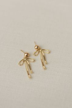 Rumor has is that 2024 is the year of BOWS! These super cute, dangly bow earrings will be the HIT of any party. Includes two gold or silver-plated dangly bow charms 6mm 14k gold-filled or sterling silver, hypoallergenic ball studs Choose from either solid or sparkly Delicate Earrings Gold, It Girl Earrings, Dangly Earrings Gold, Dainty Jewelry Earrings, Gold Dangly Earrings, Bow Earrings Gold, Silver Charm Earrings, Gold Bow Earrings, Dangly Earrings Aesthetic