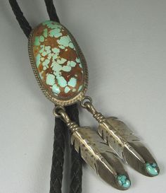 A gorgeous elongated oval cabochon of natural Royston Turquoise with prominent brown matrix is held in place by a twisted wire rope bezel from which are suspended two very realistically fashioned eagle feathers, each with their own cab of turquoise. Will adorn with its design, main stone, as well as movement when worn. Red Tail Hawk, Indigenous Jewelry, Desert Beauty, Taos Pueblo, Eagle Feathers, Elongated Oval