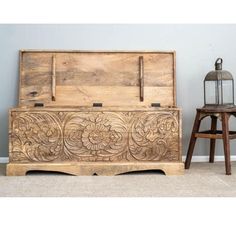 an old wooden chest sitting next to a stool