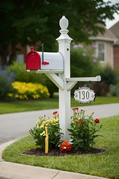 a mailbox in the middle of a flower bed