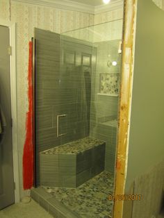 a walk in shower sitting inside of a bathroom