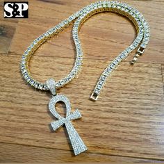 New Hip Hop Ankh Pendant & 18" Full Iced 1 Row Diamond Tennis Choker Chain Set Hip Hop Celebrity Style Brand New Product Description 1 Row Diamond Necklace : Chain Length : 18" Chain Width : 4mmcolor: 14k Gold Platedlab Simulated Diamonds Ankh Pendant : 14k Gold Plated Size Of Pendant : 60mm X 25mm Lab Diamonds On Pendant High Quality And Polished. Gold Ankh Chain Necklace, Dope Jewelry Accessories, Family Jewels, Mens Accessories Jewelry, Dope Jewelry, Lab Diamonds, Chain Lengths, New Product, Diamond Necklace