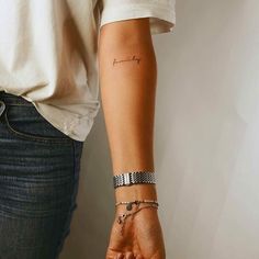 a woman's arm with a tattoo on it and the word love written in cursive writing