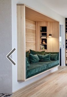 a living room filled with furniture and wooden shelves