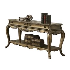 an antique style desk with books on it