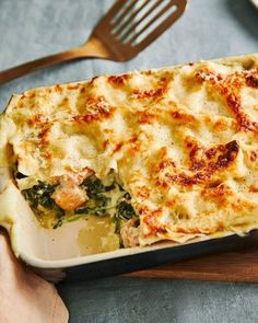 a casserole dish with cheese and spinach