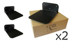 two black shelf brackets on top of a cardboard box