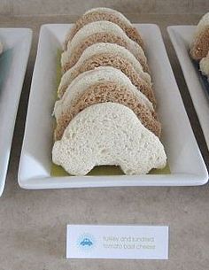 several plates with sandwiches on them sitting on a table