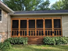 a house that has some plants growing on the front porch and side of the house