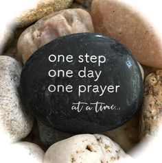 a rock with the words one step, one day, one prayer at a time