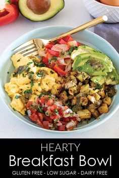 a bowl filled with eggs and vegetables next to sliced avocado