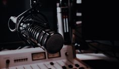 a microphone and sound board in a recording studio