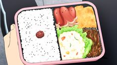 a person is holding a bento box filled with sushi and other food items