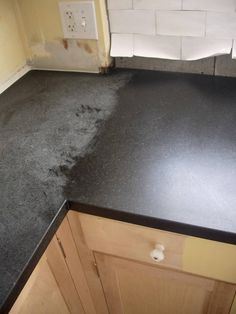 a black counter top in a kitchen under construction