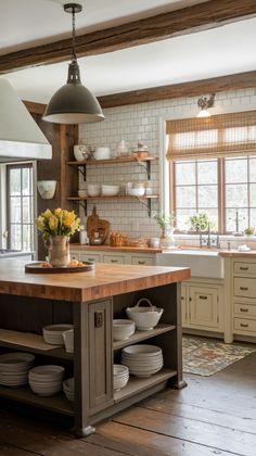 a kitchen island with plates stacked on it