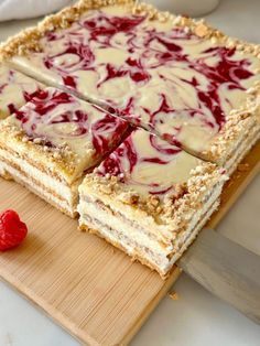 a cake that has been cut into pieces and is sitting on a wooden cutting board