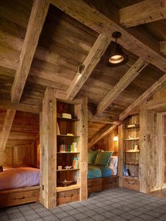 an attic bedroom with wooden walls and flooring