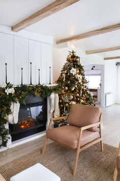 a living room with a christmas tree and fireplace