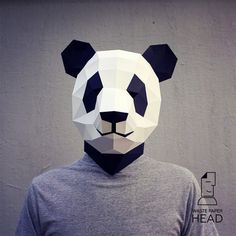 a man wearing a panda mask made out of paper