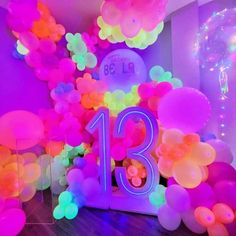 balloons and streamers decorate the entrance to a 13th birthday party