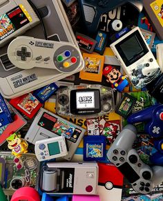 a pile of video game controllers and games on display in front of the camera lens